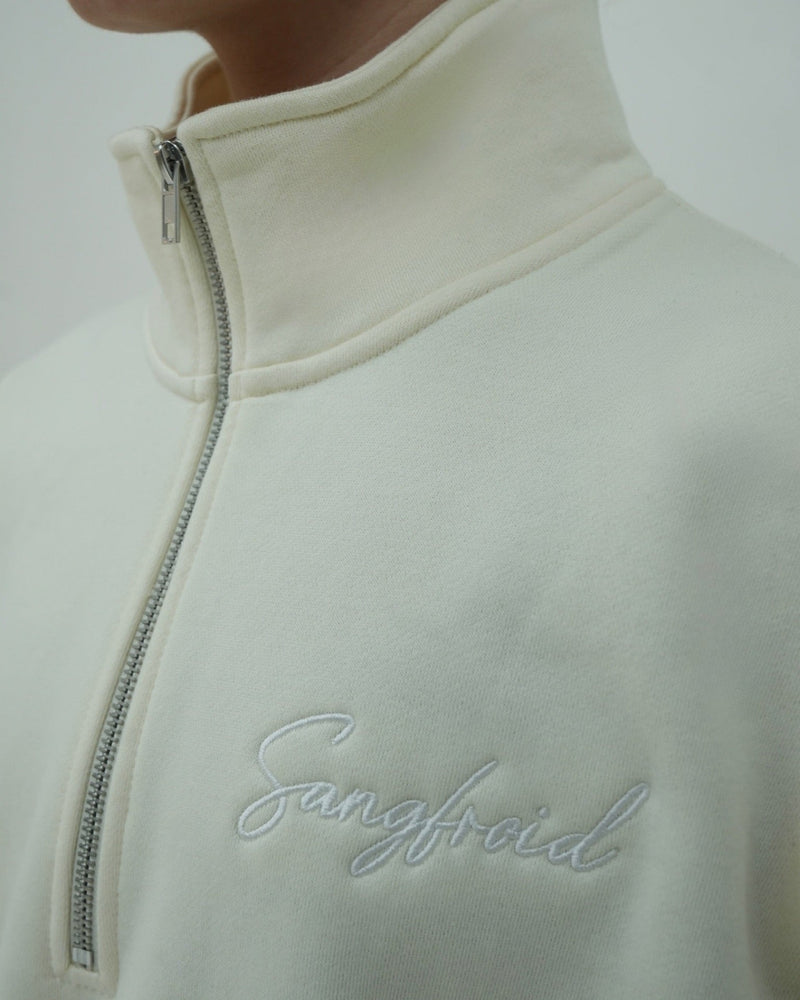 Close-up of a light gray fleece jacket with 'Sangfroid' embroidery on a white background