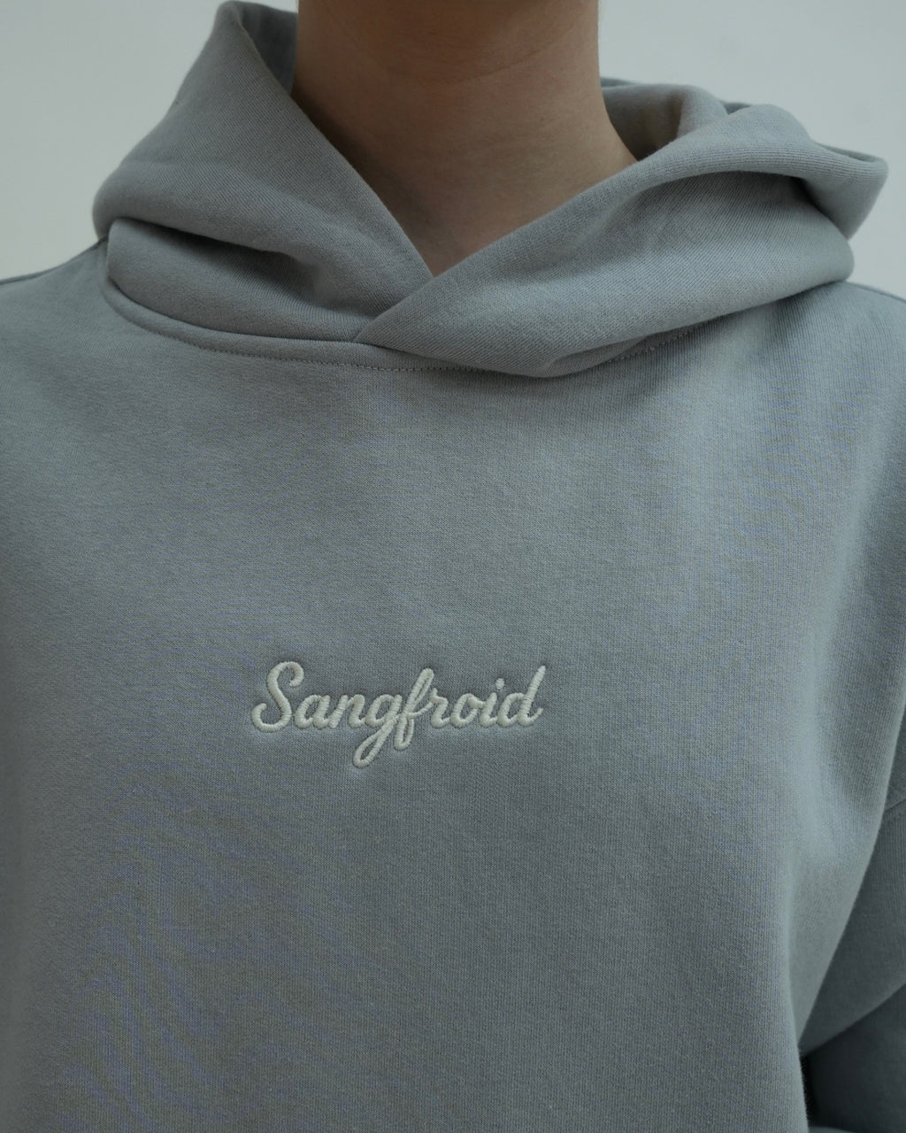Gray hoodie with 'Sangfroid' embroidery on a plain background