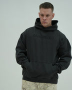 Man wearing a black hoodie with 'SANGFROID' branding on a gray background