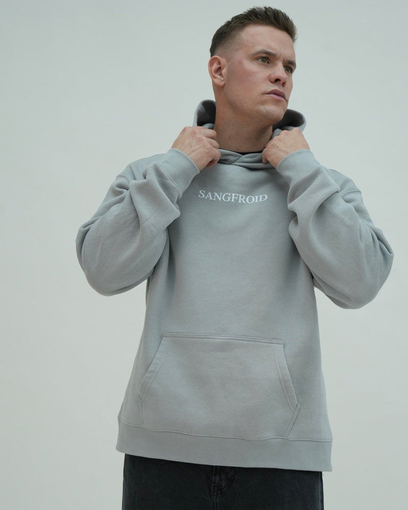 Man wearing a gray hoodie with 'Sangfroid' branding on a plain background