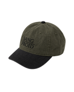 A two-tone baseball cap with an olive green washed fabric crown and a black curved brim. The front of the cap features the embroidered text 'SANG FROID' in black.