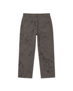 A pair of dark brown trousers with a subtle tonal floral jacquard pattern, shown from the back on a plain white background.