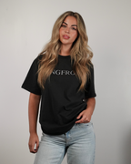 Woman wearing a black t-shirt with 'SANGFROID' logo against a plain background