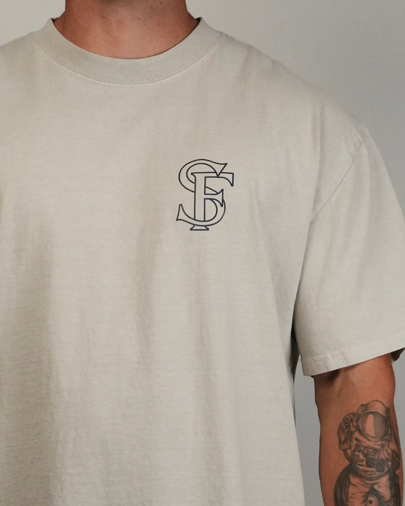 Beige t-shirt with a logo on the chest against a neutral background