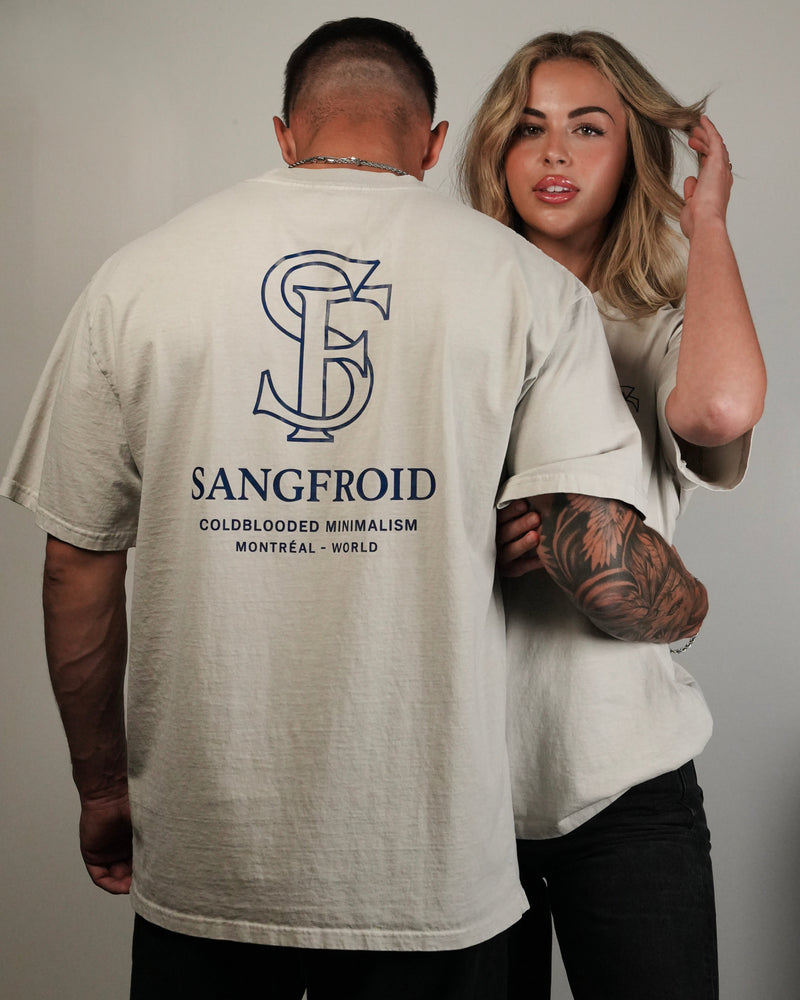 Man wearing a beige t-shirt with 'Sangfroid' logo and text, standing next to a woman.