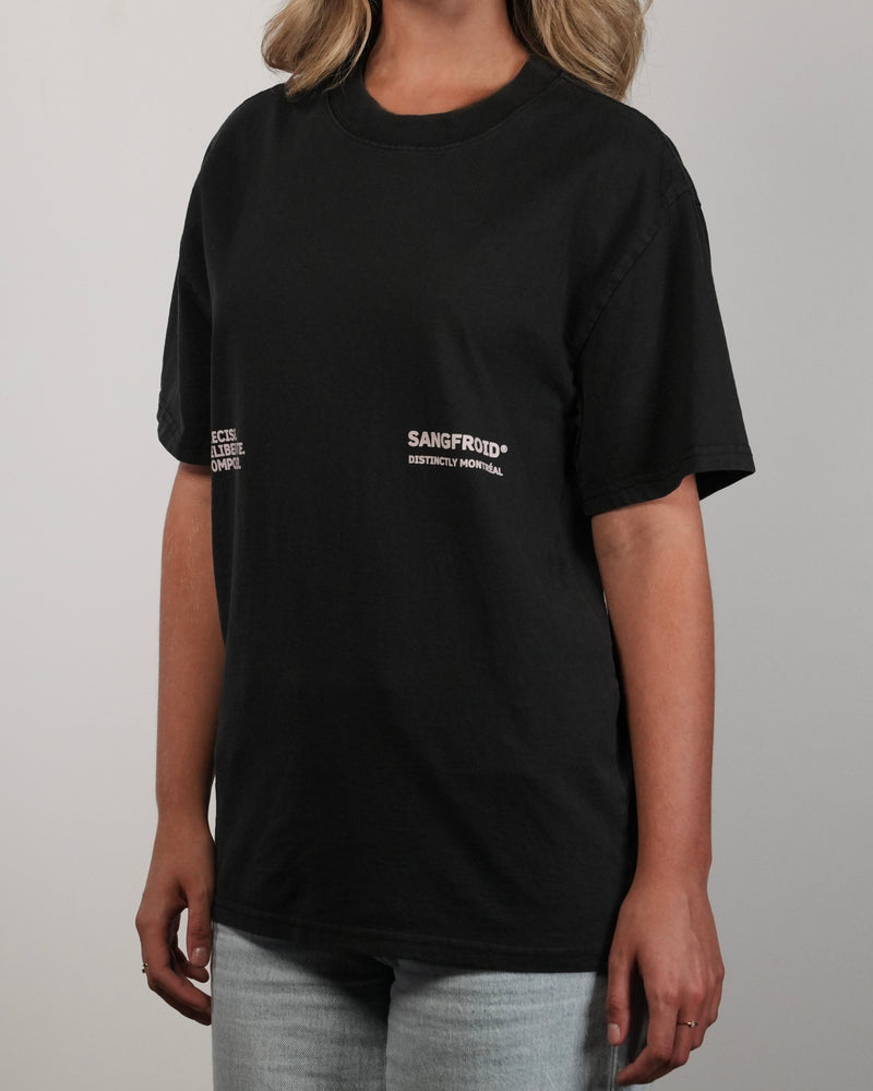 Person wearing a black t-shirt with 'Sangfroid' branding on a plain background