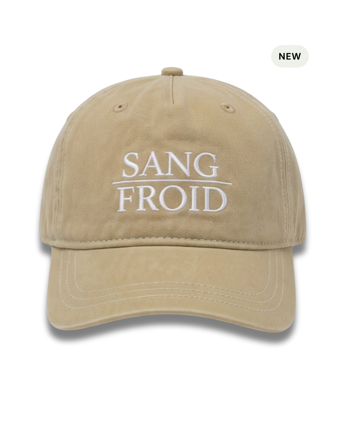 A beige washed cotton baseball cap with white embroidered text reading 'SANG FROID' on the front, shown against a plain white background with a small 'NEW' badge in the top right corner.